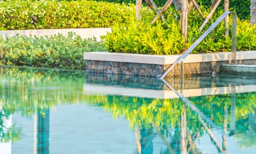 Outdoor swimming pool with umbrella chair lounge around there for leisure travel and vacation concept